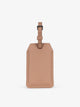 CALPAK Portable Luggage Tag + Charger with faux leather exterior in 
brown; APT2401-CARAMEL