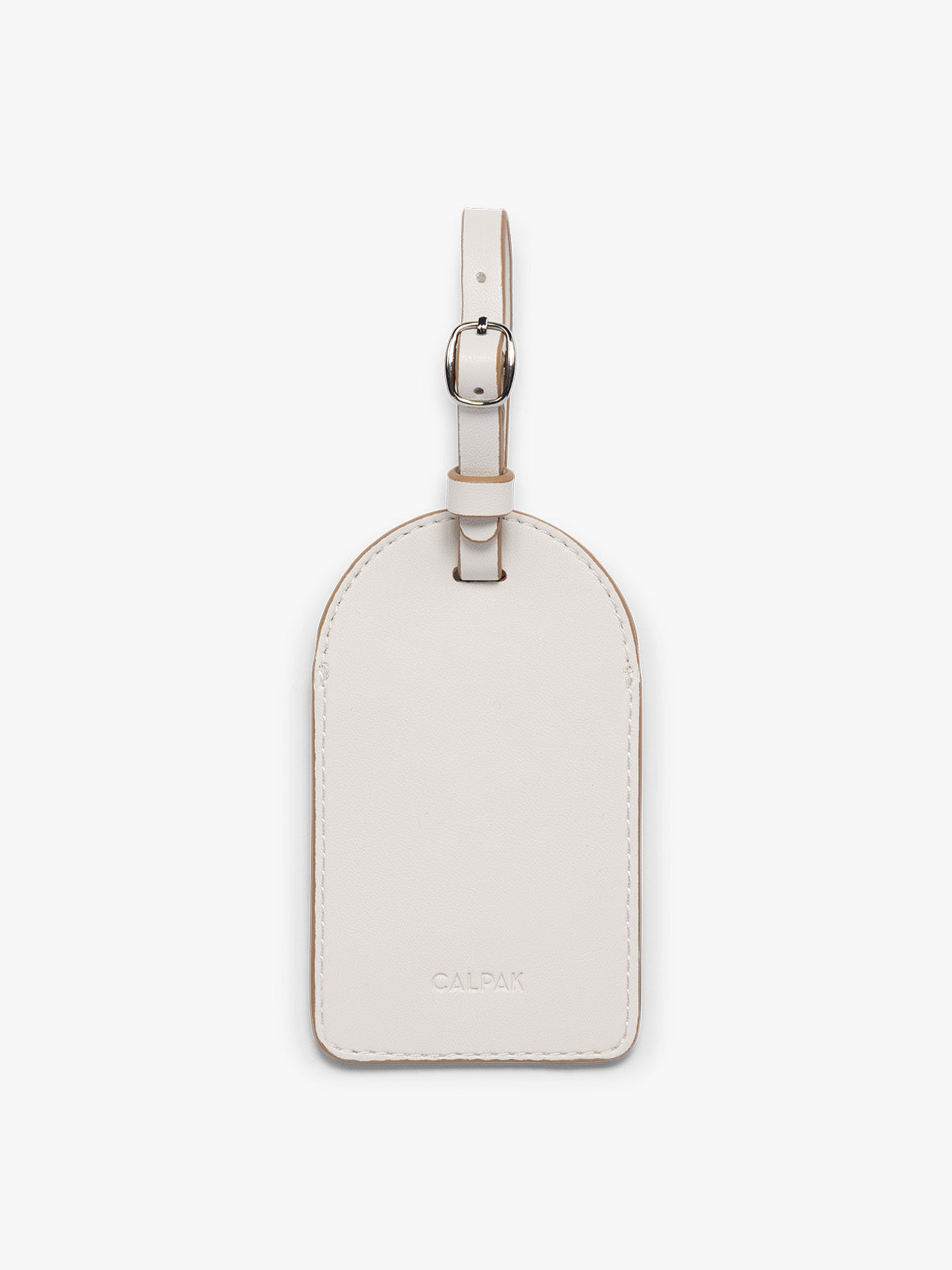 A cream CALPAK Luggage Tag with a matching strap and silver-tone metal buckle, featuring the embossed brand name 'CALPAK' at the bottom, shown on a clean white background; PWTS2601-VANILLA