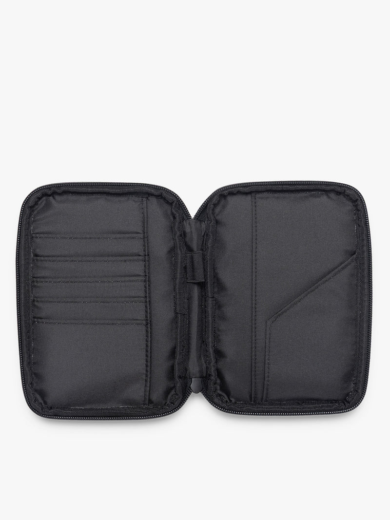 Opened interior of CALPAK Luka Zip Passport Wallet in metallic grey on a white background