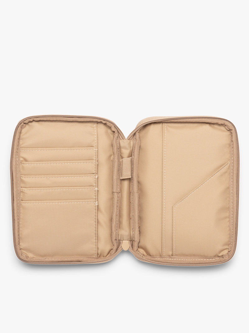 Opened interior of CALPAK Luka Zip Passport Wallet in beige Latte on a white background