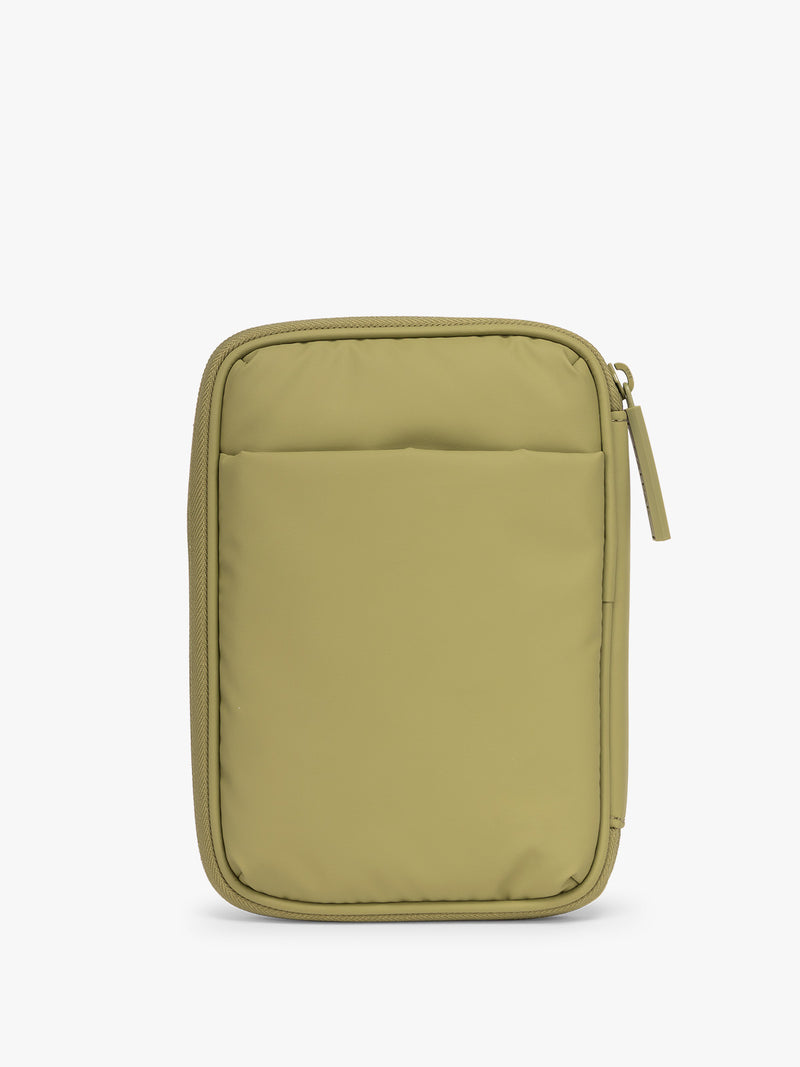 Back side with pocket of CALPAK Luka Zip Passport Wallet in dark green Pistachio on a white background