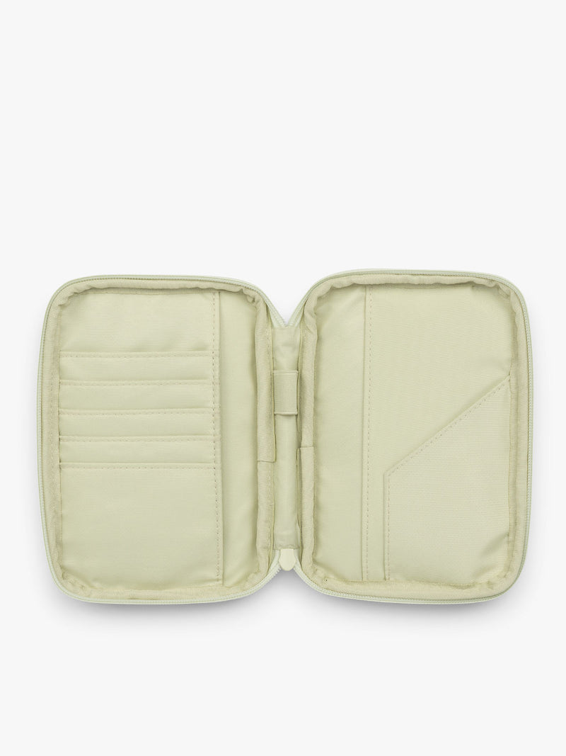 Opened CALPAK Luka Zip Passport Wallet in light green Celadon