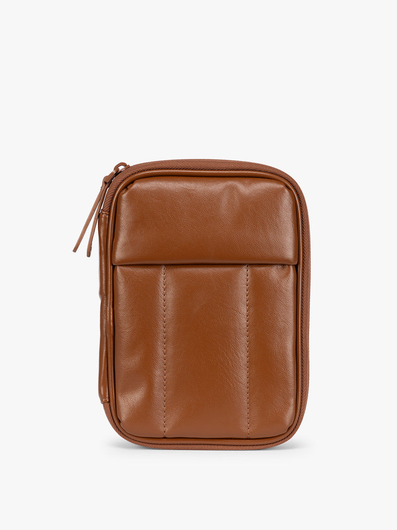 A light Honey Brown CALPAK Luka Zip Passport Wallet in vegan leather with a zippered top and a front pocket, shown on a plain white background