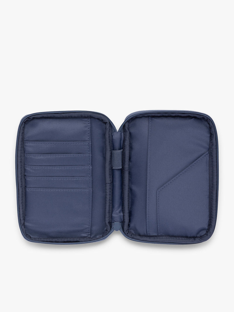 Opened view of CALPAK Luka Zippered Passport Wallet in dark blue metallic material in Metallic Indigo