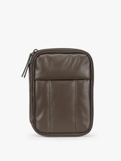 A dark brown Mushroom CALPAK Luka Zip Passport Wallet in vegan leather with a zippered top and a front pocket, shown on a plain white background; PZW2301-MUSHROOM-PU view 1