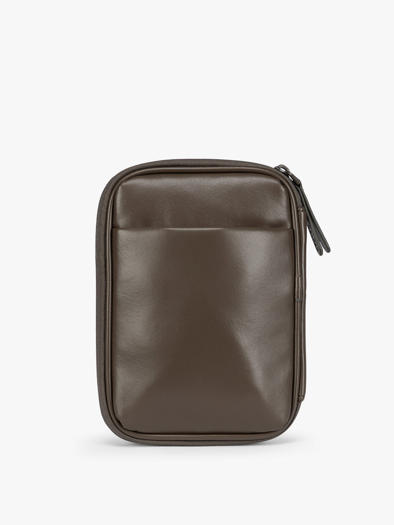 Backside of a dark brown Mushroom CALPAK Luka Zip Passport Wallet in vegan leather with a zippered top and a front pocket, shown on a plain white background