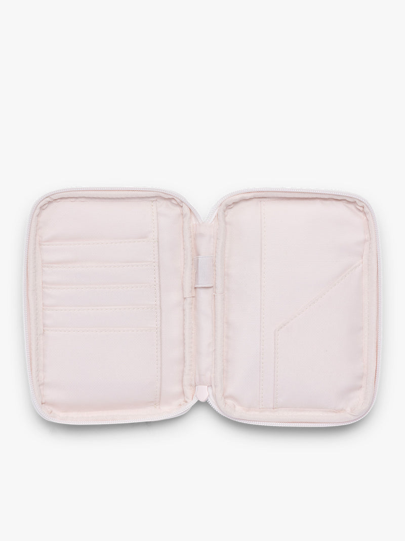 Opened CALPAK Luka Zip Passport Wallet in light pink shiny Pearlescent