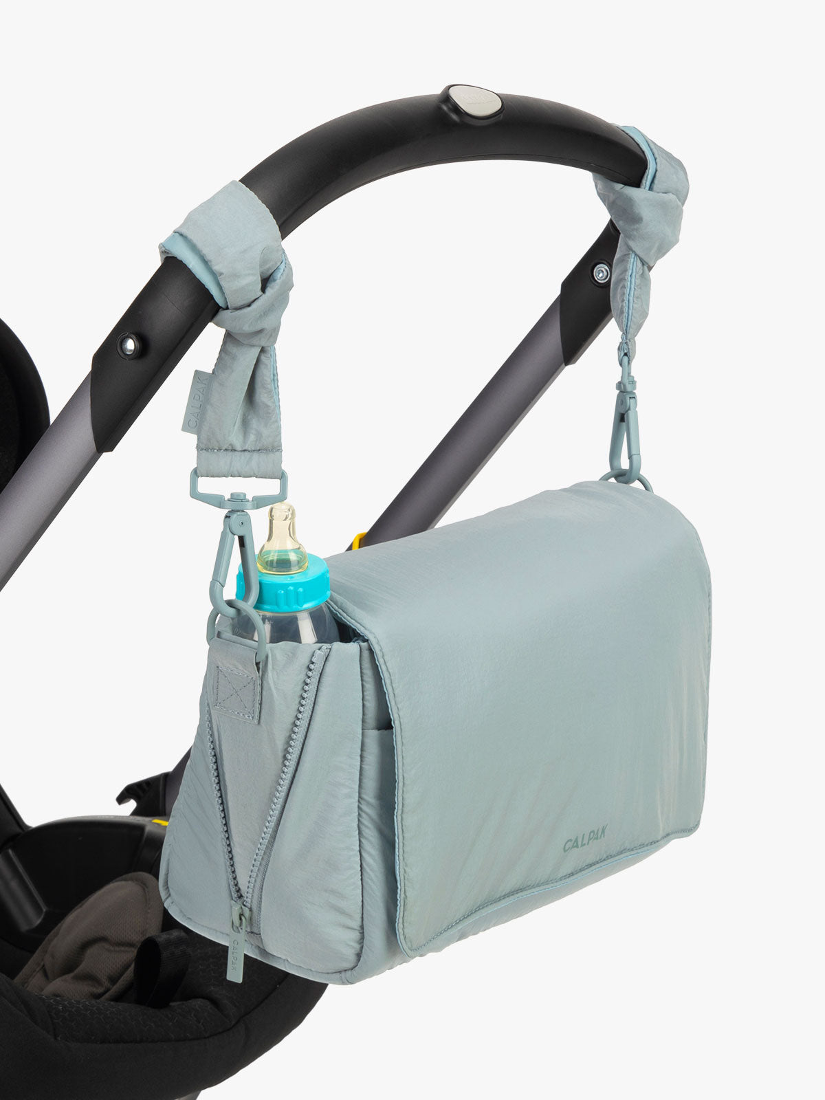 CALPAK Convertible Stroller Caddy Crossbody in light blue Bluebell hanging on stroller with stroller straps; SCB2401-BLUEBELL