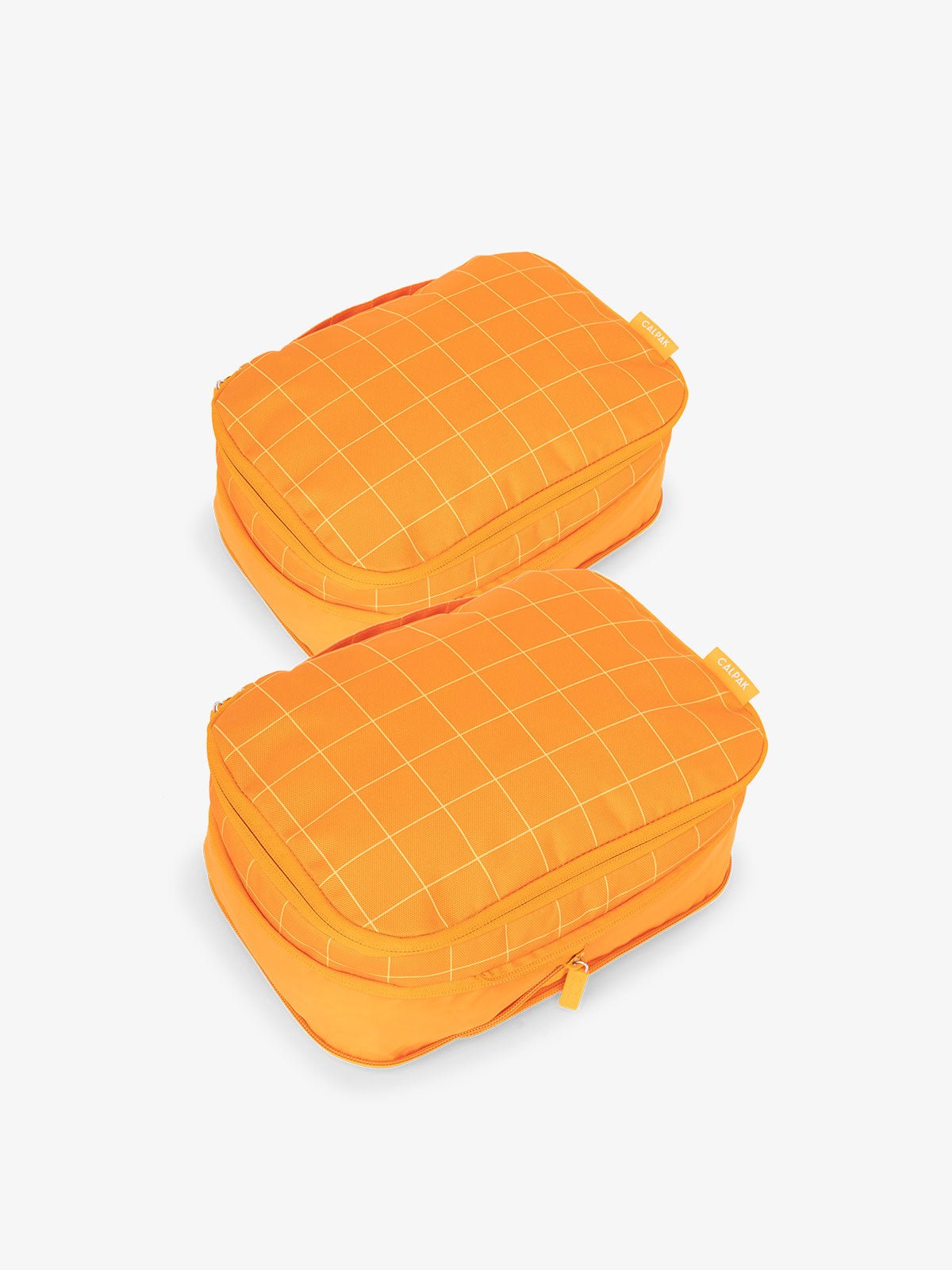 CALPAK small compression packing cubes with top handles and expandable by 4.5 inches in orange grid