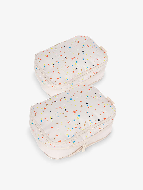 CALPAK small compression packing cubes with top handles and expandable by 4.5 inches in off-white and colorful speckle