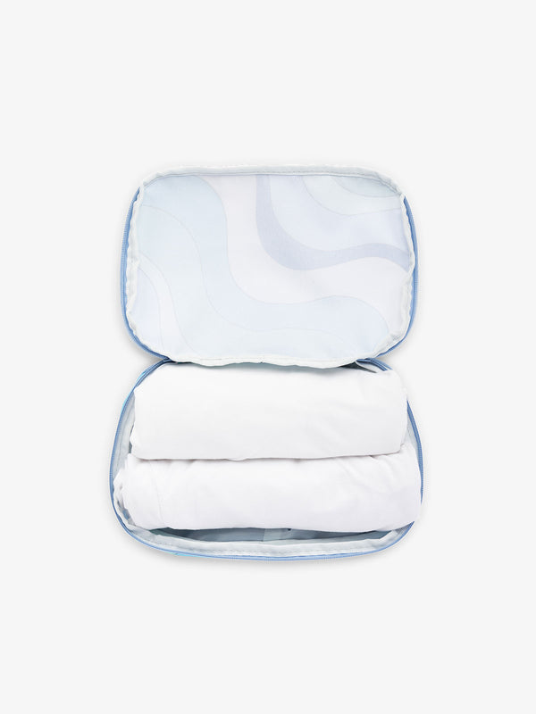 CALPAK small packing cubes for travel made with durable material in blue wavy print