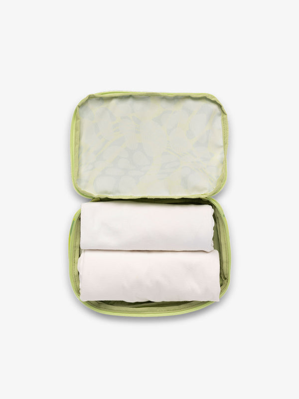 CALPAK small packing cubes for travel made with durable material in green abstract print