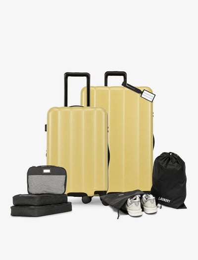CALPAK starter bundle with carry-on, large luggage, packing cubes, pouches, and luggage tag in butter; LCO8000-BUTTER