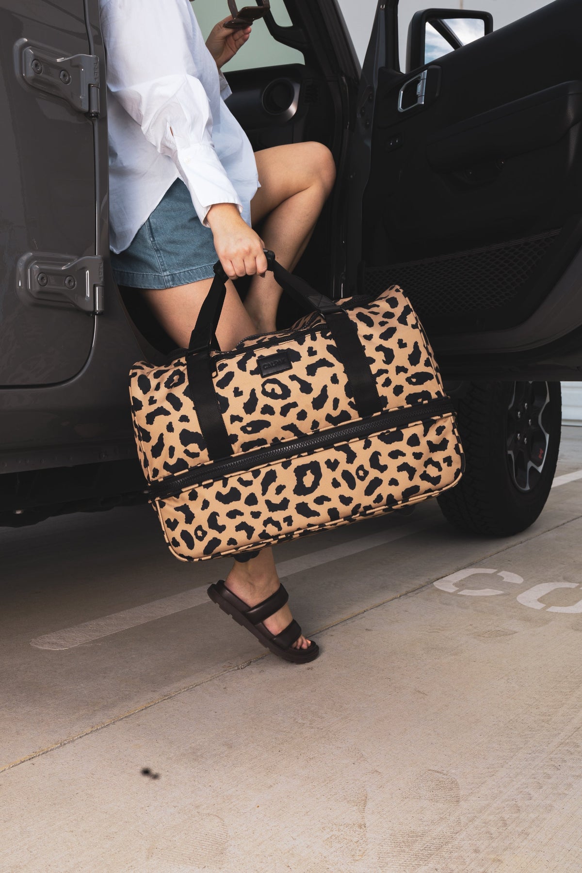 model with CALPAK weekender Stevyn duffel bag; DST7019-CHEETAH