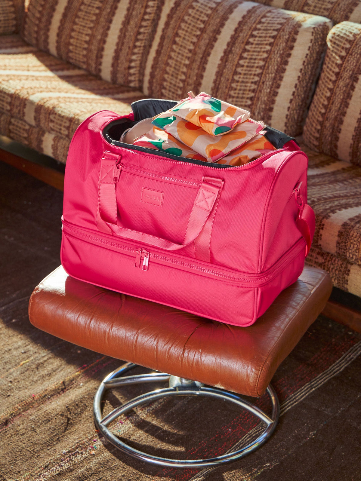 CALPAK Compakt Zippered Pouches in modern abstract within CALPAK Stevyn Duffel in dragonfruit; DST7019-DRAGONFRUIT