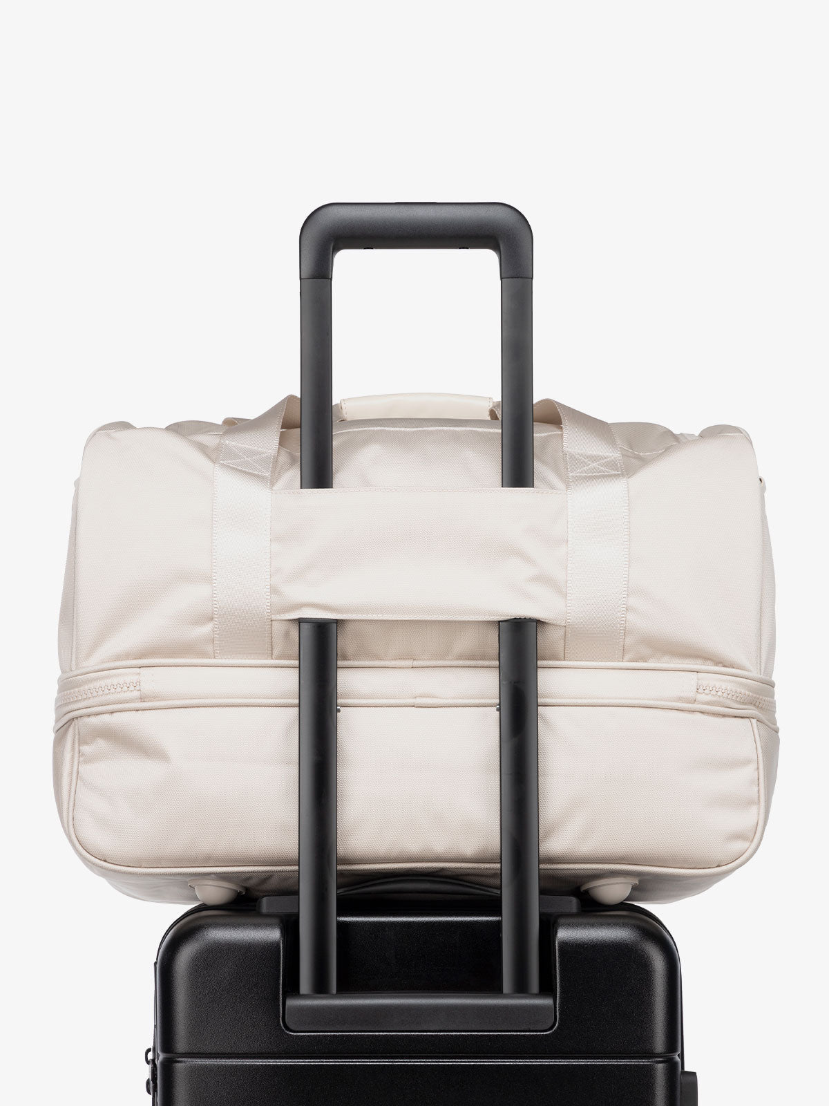 cream dune CALPAK Stevyn duffel bag with luggage trolley sleeve; DST7019-DUNE