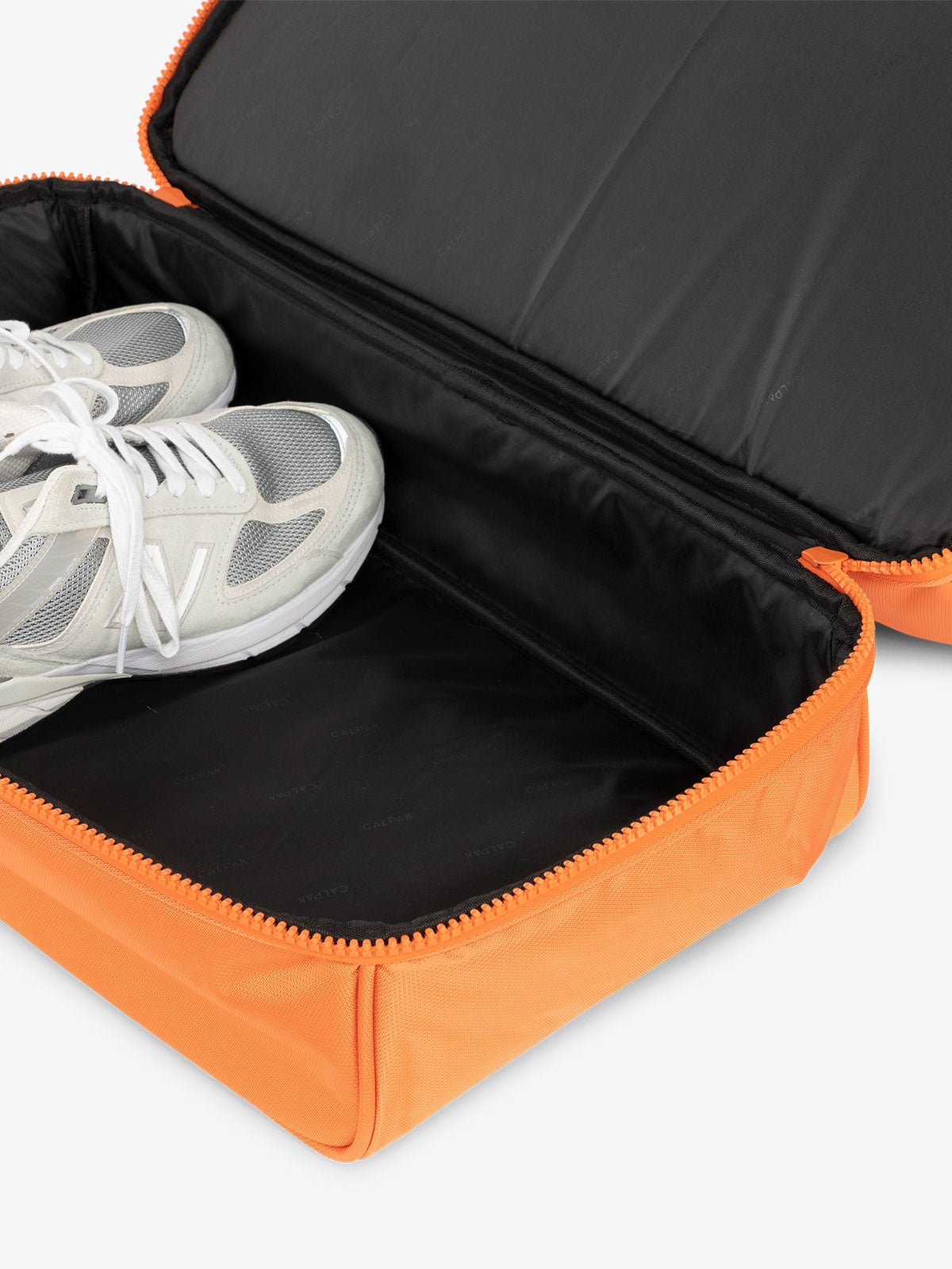 CALPAK Stevyn Duffel bag with bottom shoe compartment for travel in orange