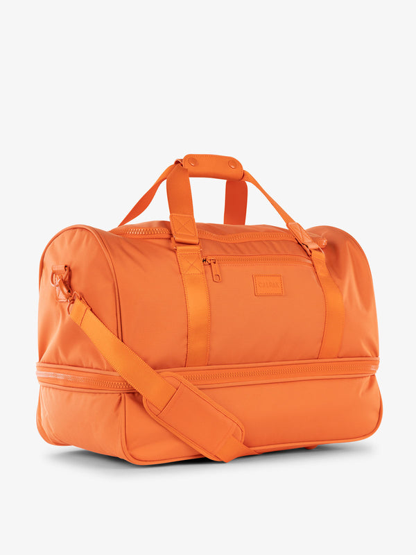 CALPAK Stevyn Duffel bag with removeable padded crossbody strap in orange