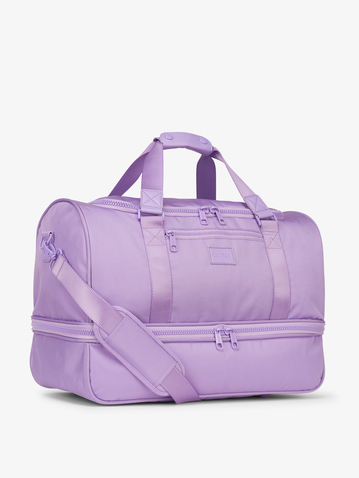 Side-view of purple orchid CALPAK Stevyn Duffel with strap, carry handles, and zippered compartments; DST7019-ORCHID