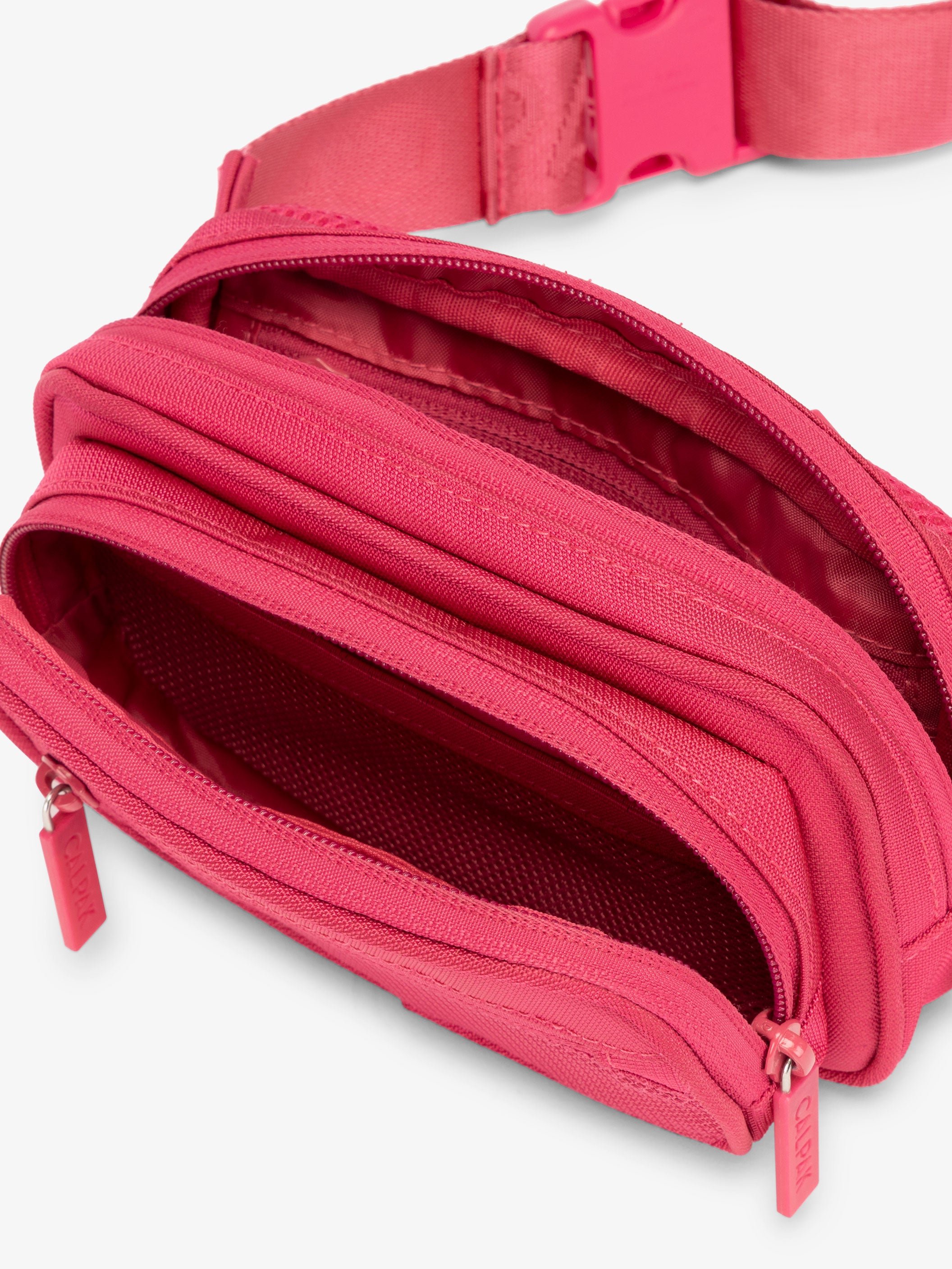 RFID CALPAK fanny pack with front zippered pocket, multiple interior and exterior pockets in pink dragonfruit