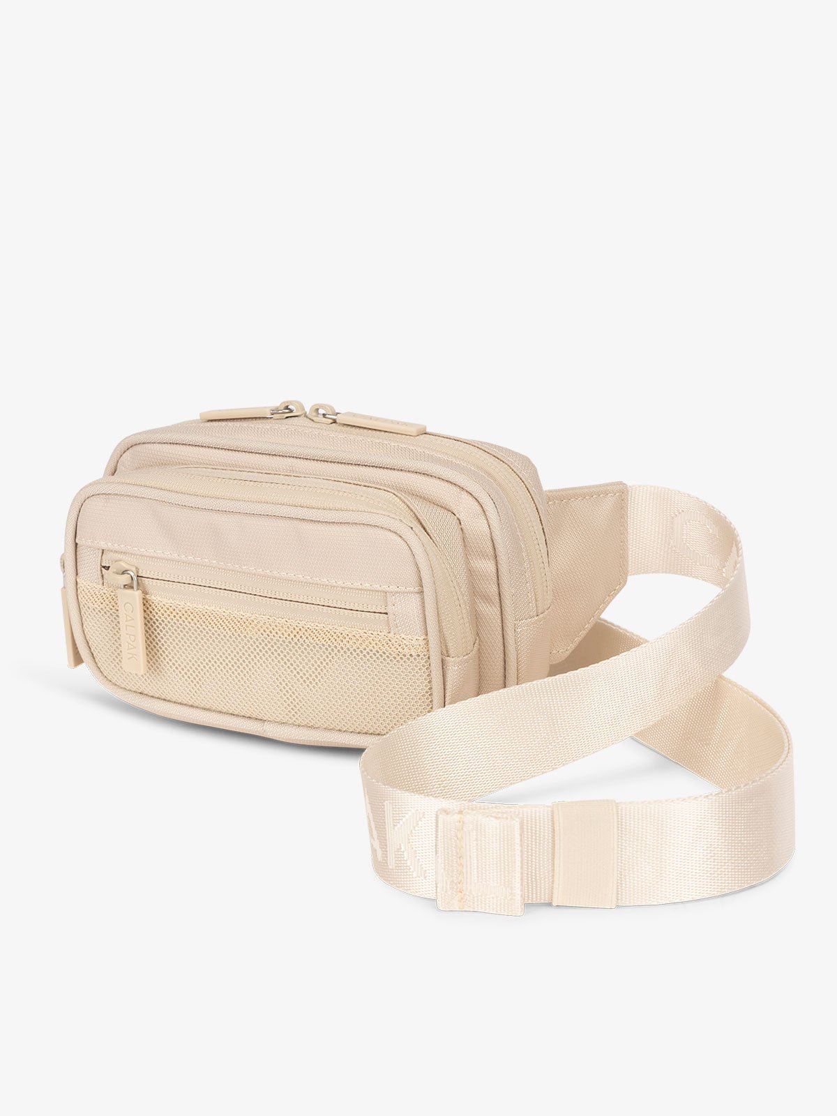 Cream colored CALPAK Stevyn Fanny Pack with adjustable crossbody strap