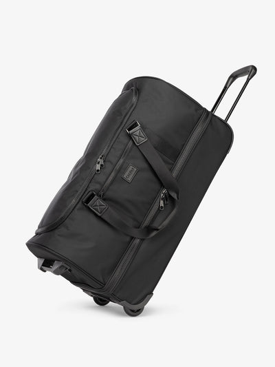 Side view of CALPAK Stevyn Large Rolling Duffel in black; DRL2301-BLACK view 1