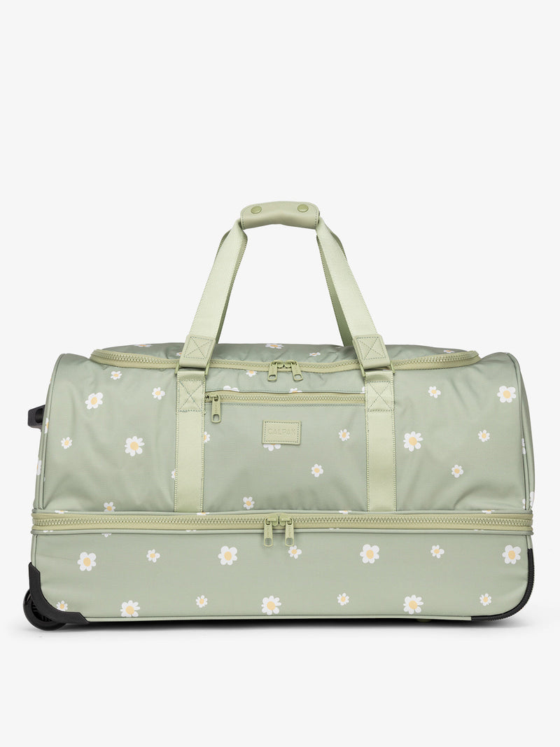 CALPAK large rolling duffel bag featuring dual handles, multiple zipper enclosed compartments, and shoe compartment in daisy
