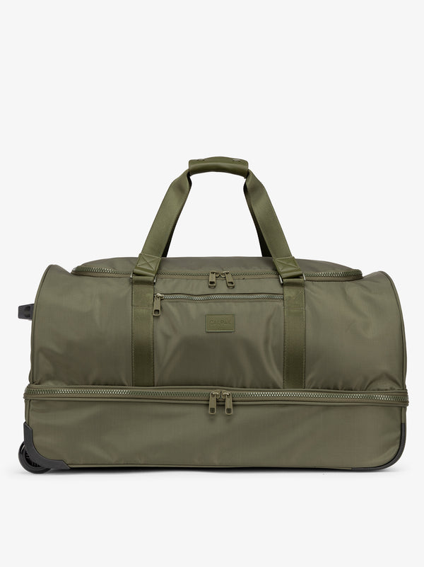 CALPAK large rolling duffel bag featuring dual handles and zipper enclosed compartments in moss