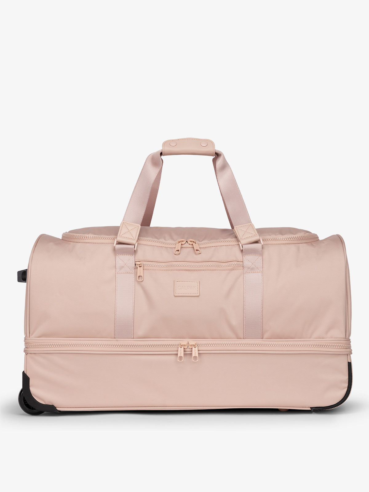 CALPAK Stevyn Large Rolling Duffel with wheels, dual handles, zipper enclosed compartments, and shoe compartment in light pink