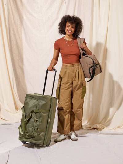 Side view of CALPAK large rolling travel duffel bag with wheels in dark green moss; DRL2301-MOSS view 2