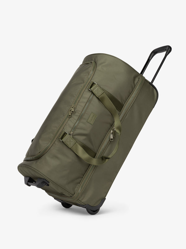 Side view of large rolling travel duffel bag with wheels in dark green moss