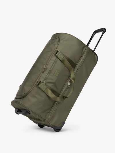 Side view of CALPAK large rolling travel duffel bag with wheels in dark green moss; DRL2301-MOSS view 1