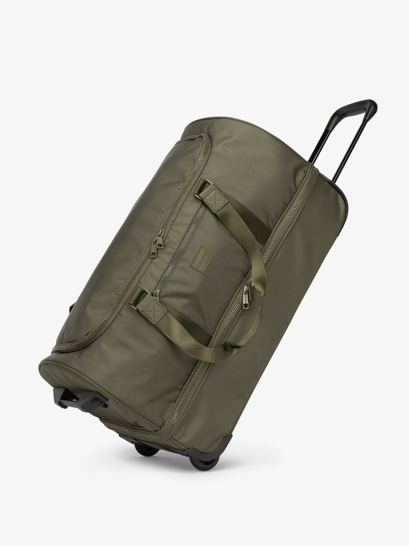 Side view of CALPAK large rolling travel duffel bag with wheels in dark green moss