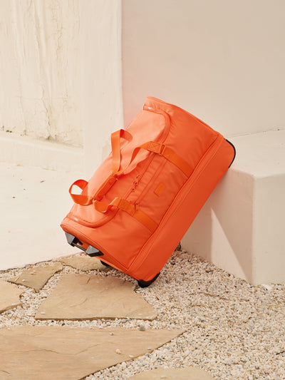 CALPAK large rolling travel duffel bag with wheels and extended top handle in orange; DRL2301-ORANGE view 2