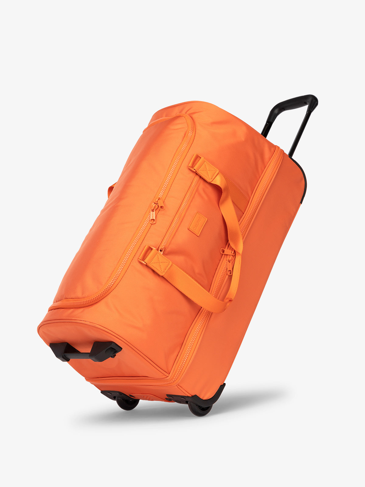 CALPAK large rolling travel duffel bag with wheels and extended top handle in orange