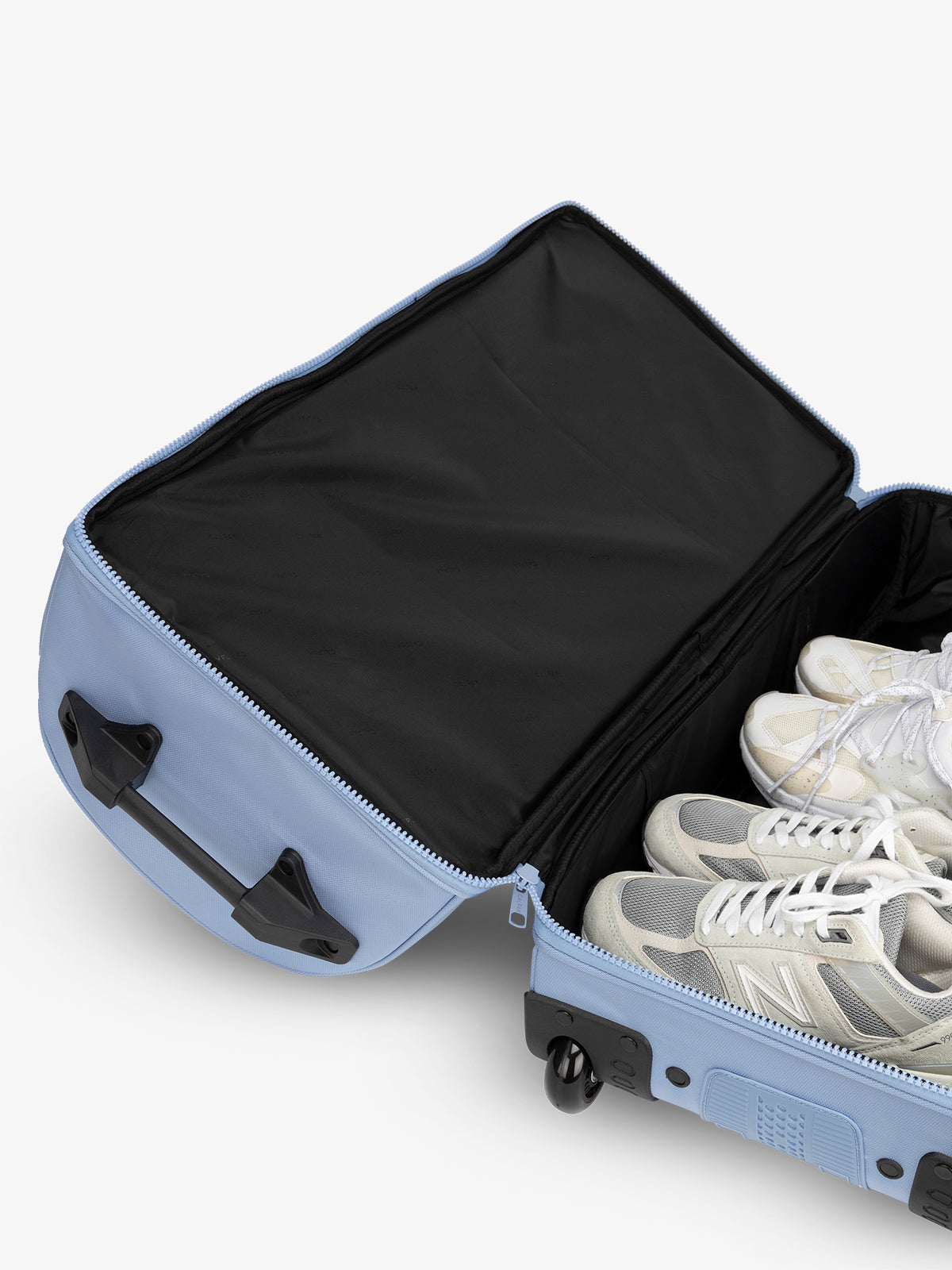Shoe compartment interior of large rolling travel duffel bag in light blue