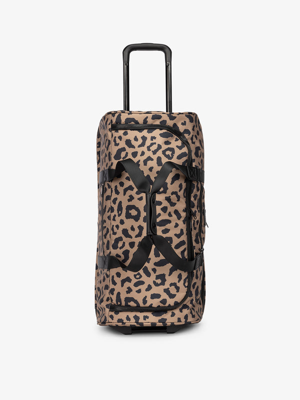 CALPAK large rolling duffel bag with wheels and top handle extended in cheetah