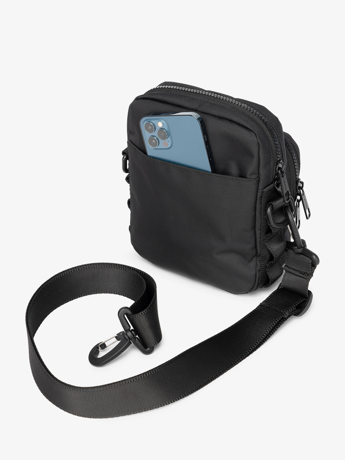 Back-view of black CALPAK Stevyn Mini Crossbody Bag with back-slip pocket for cell phone or other belongings