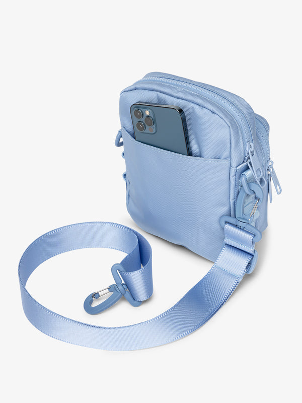 Back-view of sky CALPAK Stevyn Mini Crossbody Bag with detachable shoulder strap and back-slip pocket for cell phone or other belongings