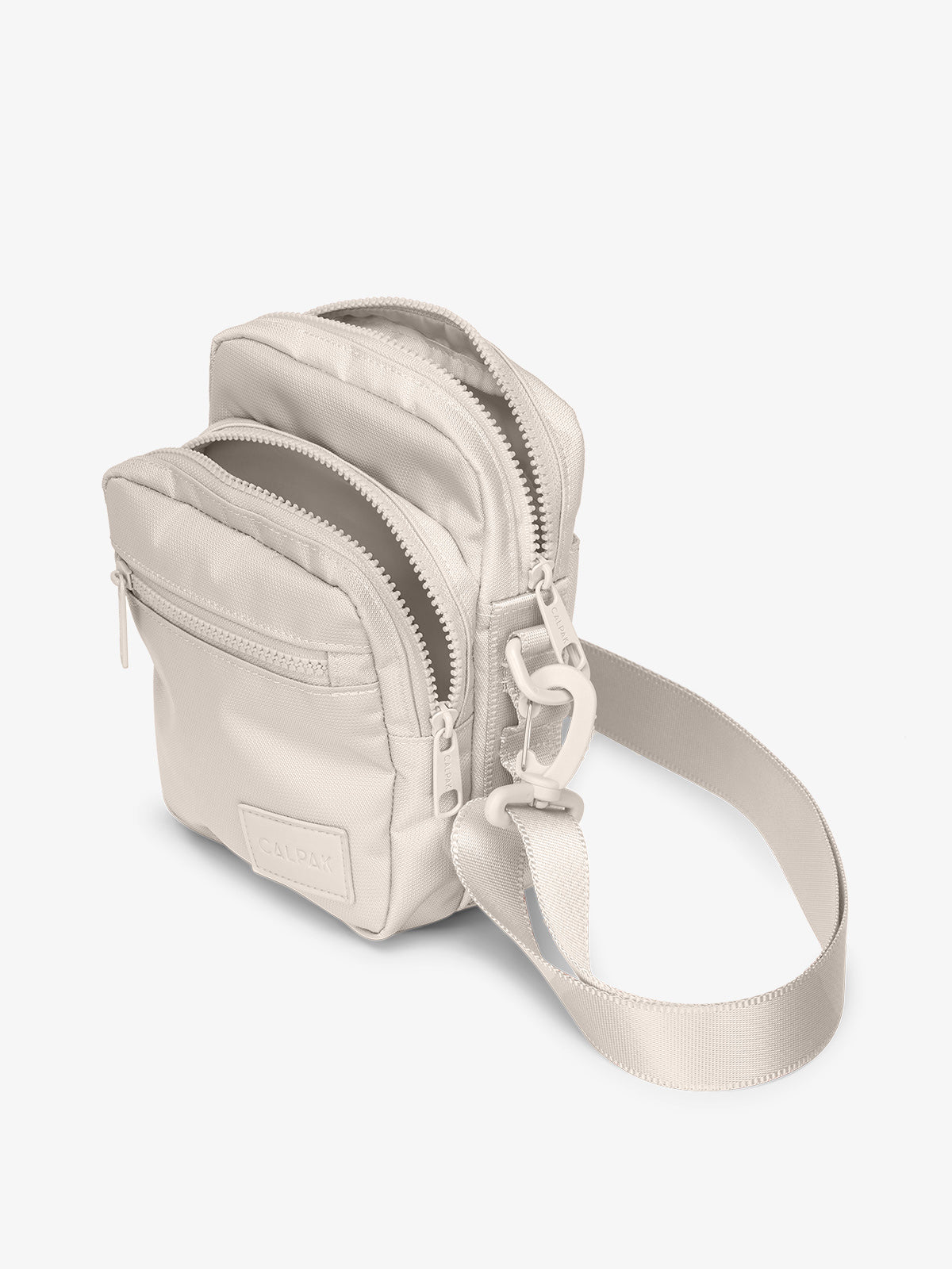 Dune CALPAK Stevyn Mini Crossbody Bag with adjustable shoulder strap, zippered pockets, and interior zipper pocket
