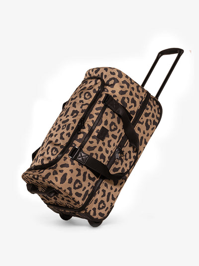 CALPAK Stevyn Rolling Duffel side view with top handle extended in cheetah; DSR2201-CHEETAH view 1
