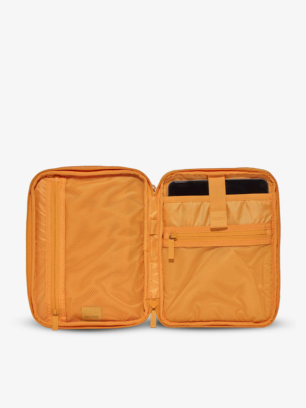 Interior of tablet organizer with zippered pockets and padded tablet sleeve in orange grid