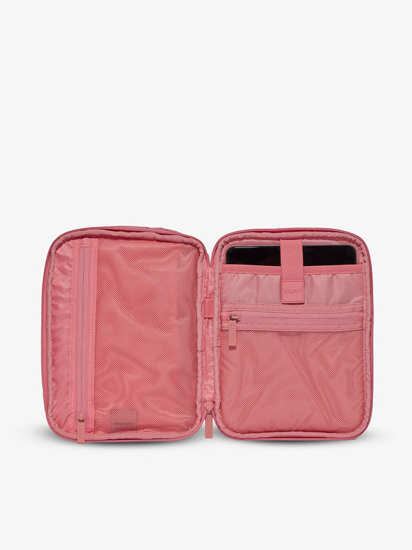 Interior of tablet organizer with zippered pockets and padded tablet sleeve in pink grid