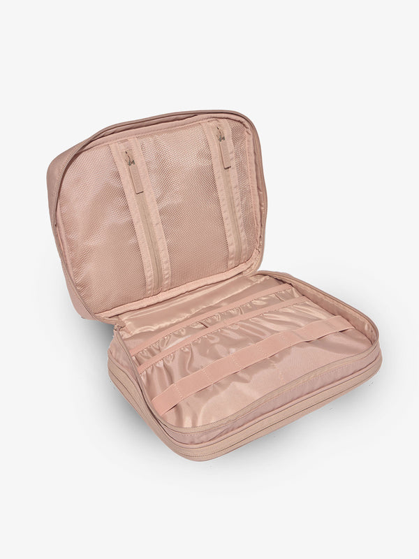 Pink tablet tech organizer features multiple pockets for organizing electronics and belongings