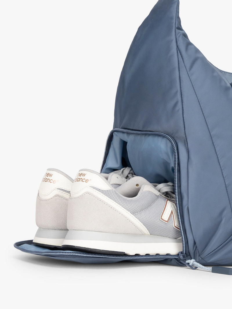 Shoe compartment for the CALPAK Fit Gym Duffel Bag in blue Indigo
