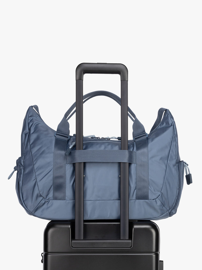 Luggage trolley sleeve for the CALPAK Fit Gym Duffel Bag in blue Indigo