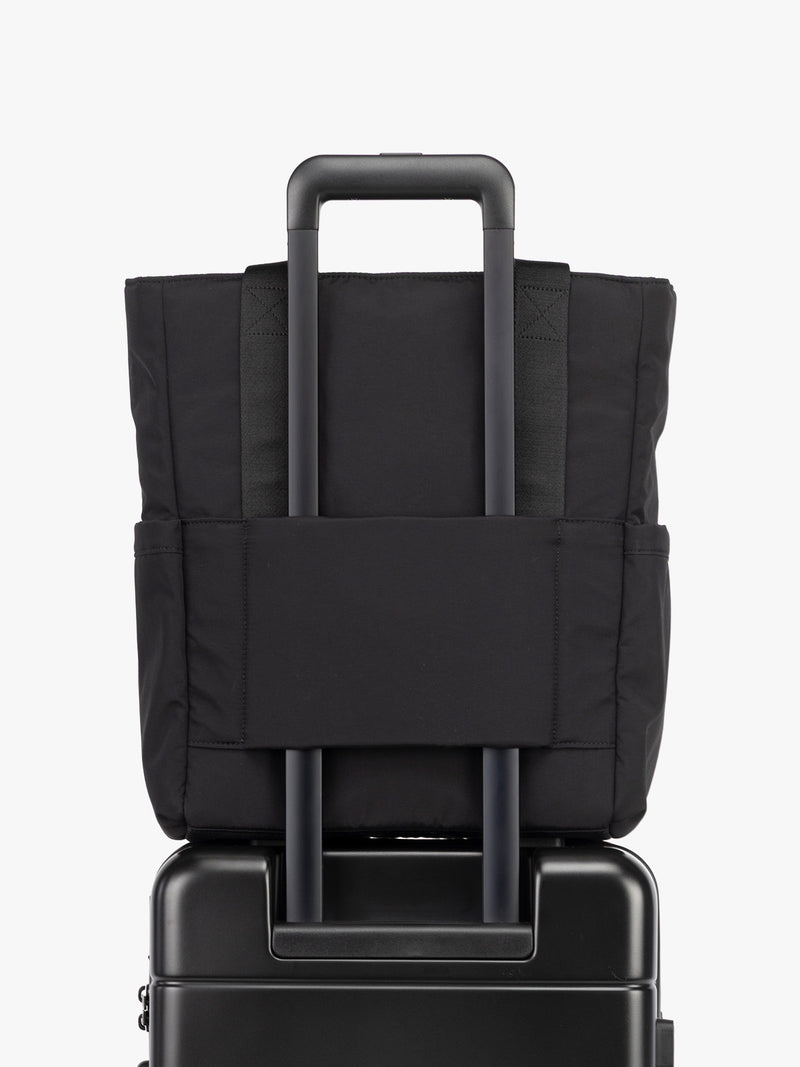 CALPAK Zippered Laptop Tote Bag in Black  on a white background with trolley sleeve