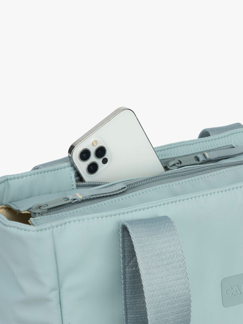 CALPAK Zippered Laptop Tote Bag in light blue Bluebell on a white background with phone pocket