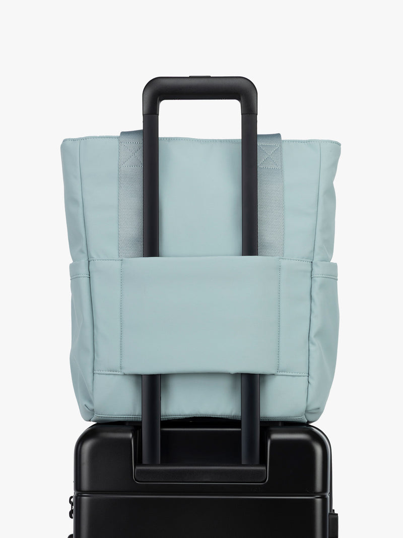 CALPAK Zippered Laptop Tote Bag in light blue Bluebell on a white background with trolley sleeve
