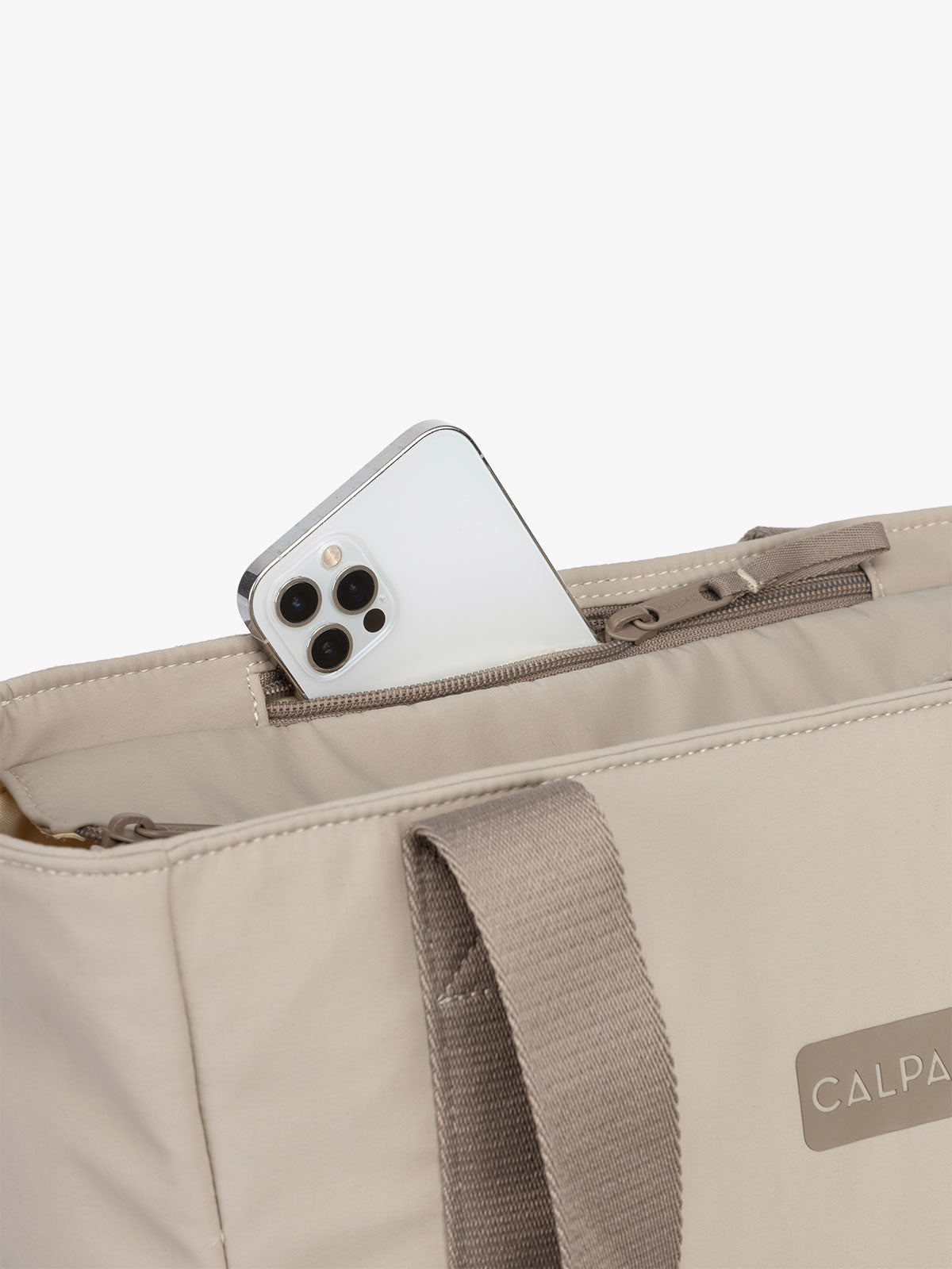 CALPAK Zippered Laptop Tote Bag in beige Greige on a white background with phone pocket; TCN2501-GREIGE
